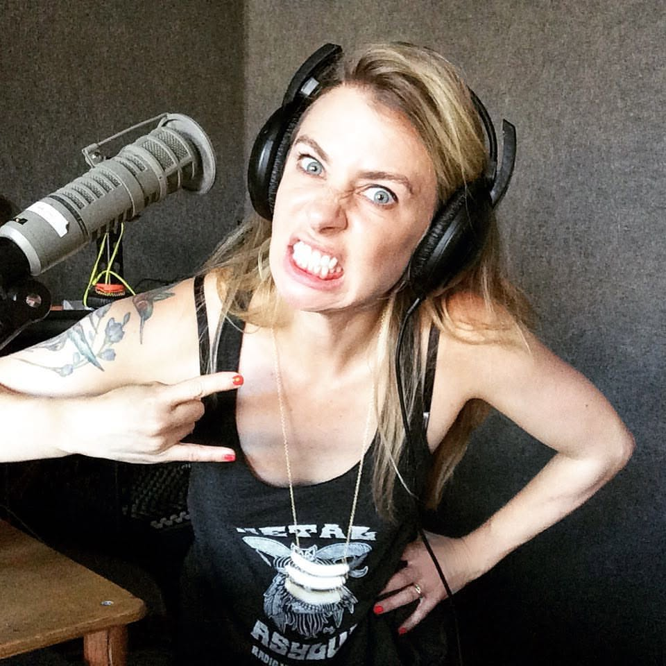 Jody Worthington wearing studio headphones at a recording microphone, making a playful face.