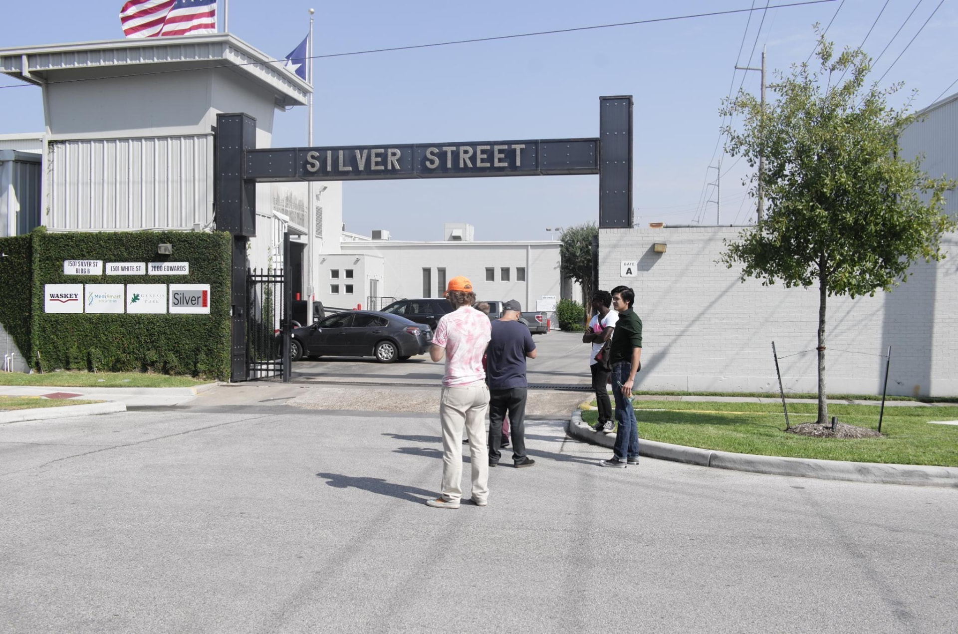 Group standing outside the Silver Street gate sign at 1501 Silver Street, 1301 White Street and 2000 Edwards during the exploratory Day for Night 2015 site visit.