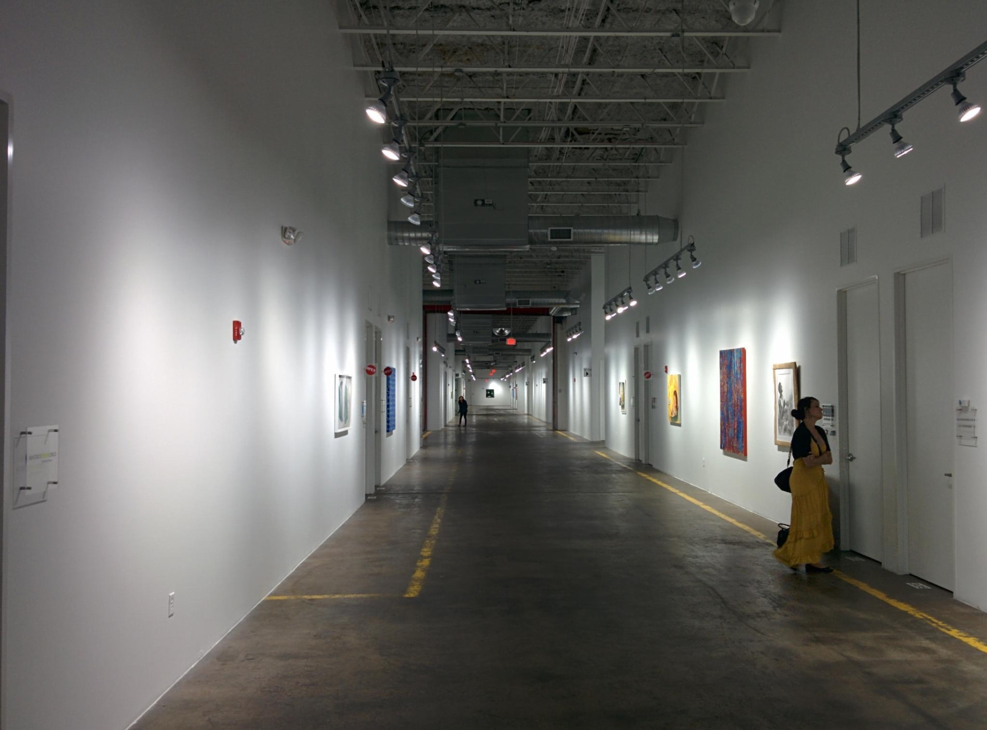 Long gallery corridor with exhibited artwork at Silver Street Studios during the exploratory Day for Night 2015 site visit.