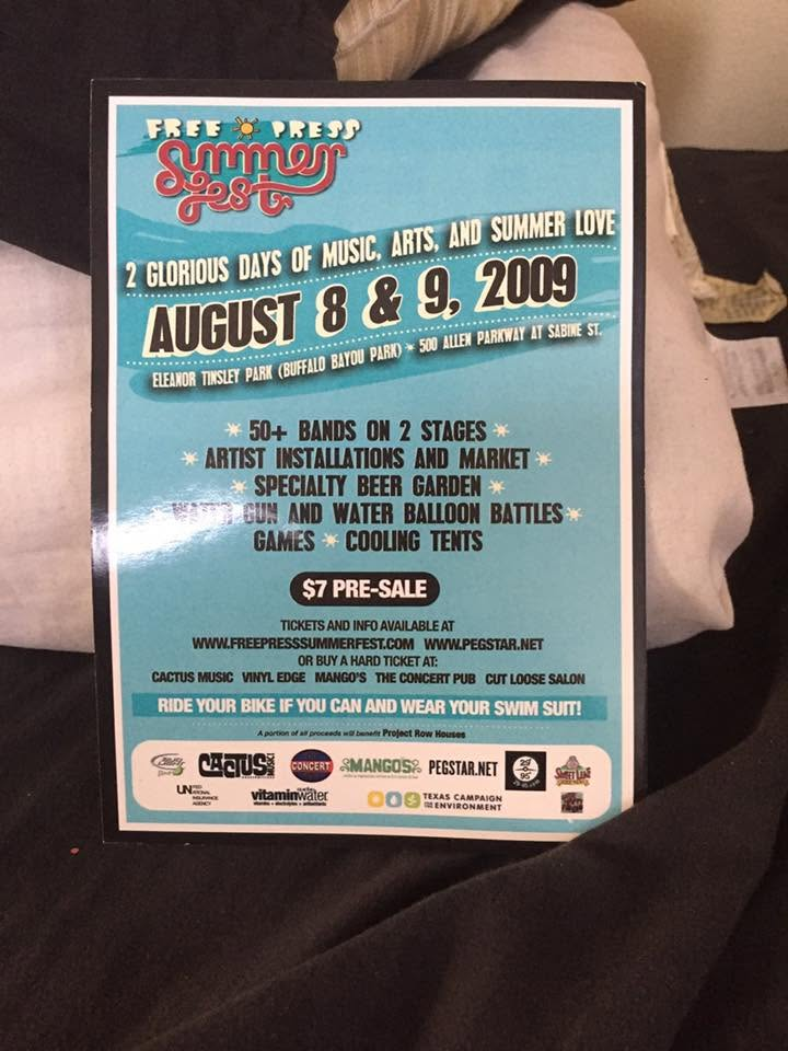 Photograph of a printed Free Press Summer Fest flyer for August 8 and 9, 2009 at Eleanor Tinsley Park, listing 50+ bands on two stages and a $7 pre-sale ticket.
