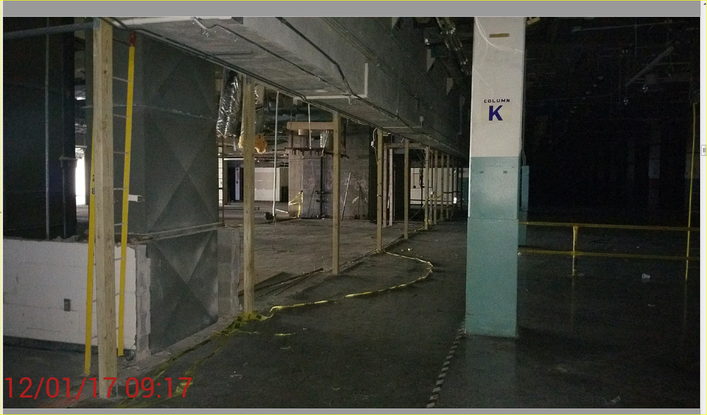Interior of the former Barbara Jordan Post Office at 401 Franklin in Houston during the Day for Night 2017 production buildout, with temporary work lighting and equipment across the unfinished floor.